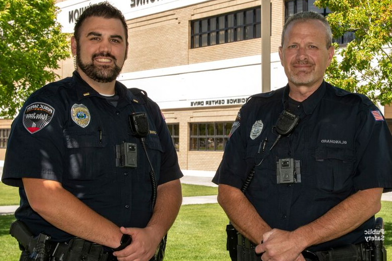 Two University Public Safety Officers smiling
