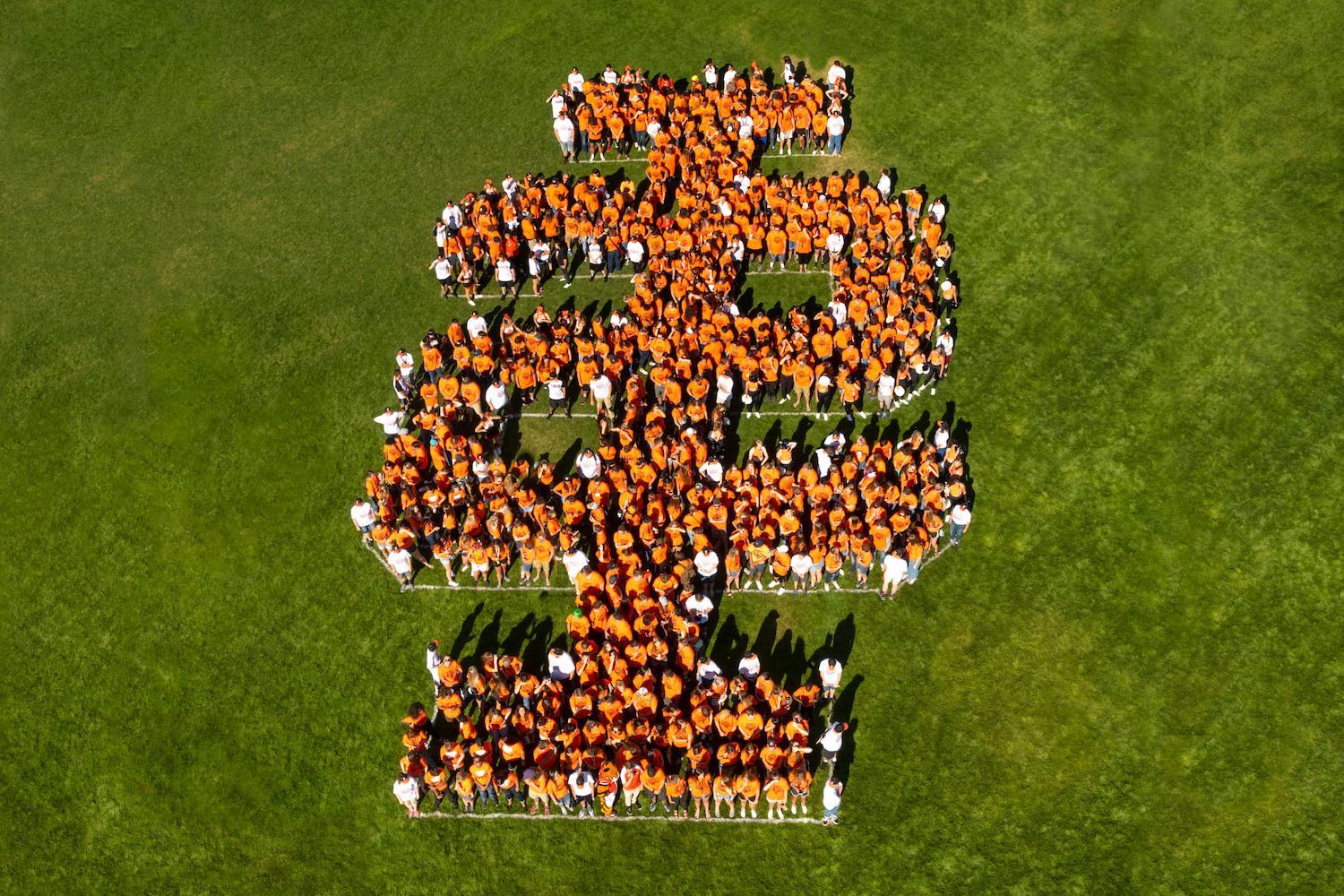 An aerial shot of ISU students grouped together to form the IS logo